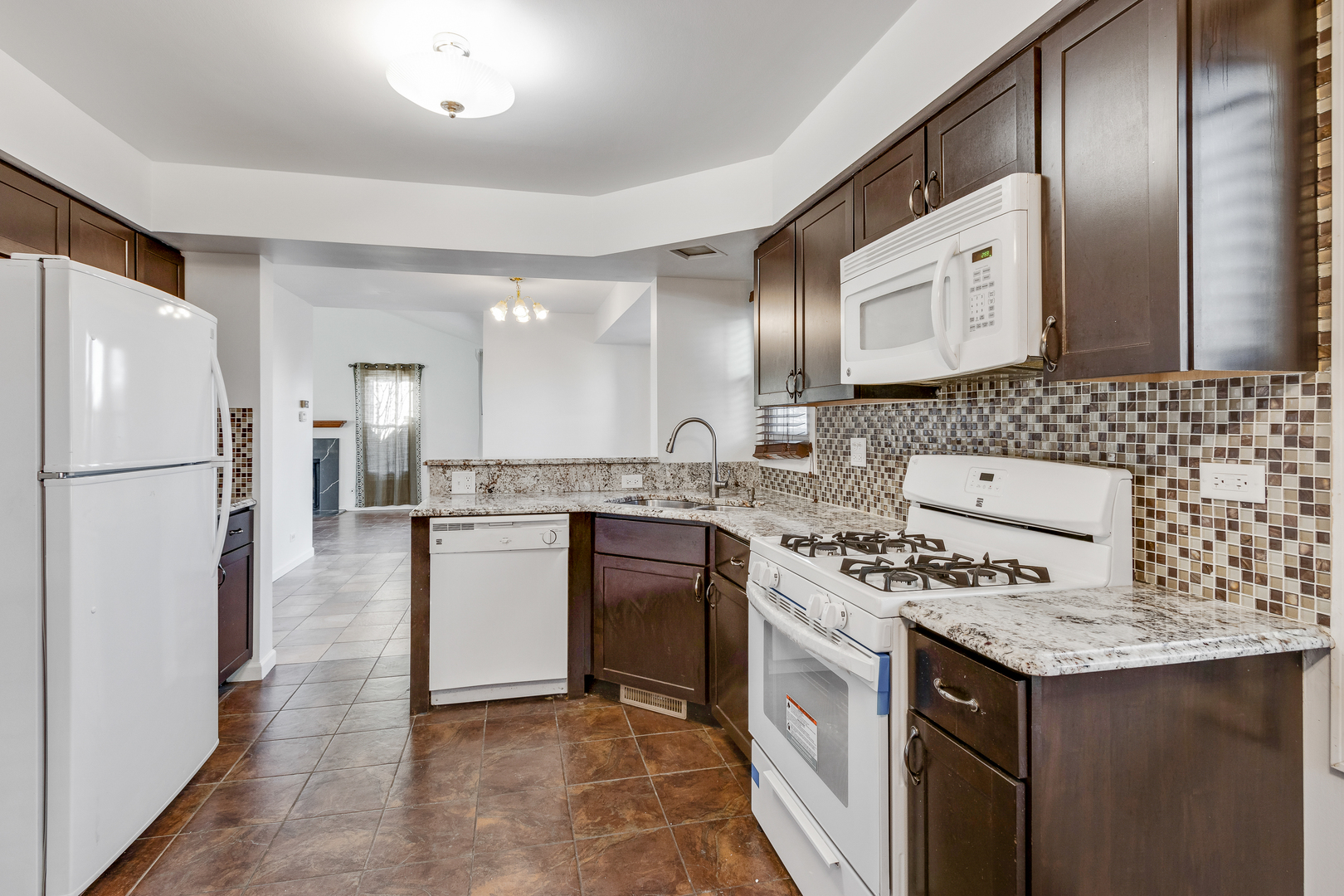 68 Jackson Lane Streamwood, IL 60107 - Photo 10 of 25 a kitchen with stainless steel appliances granite countertop a sink stove and refrigerator