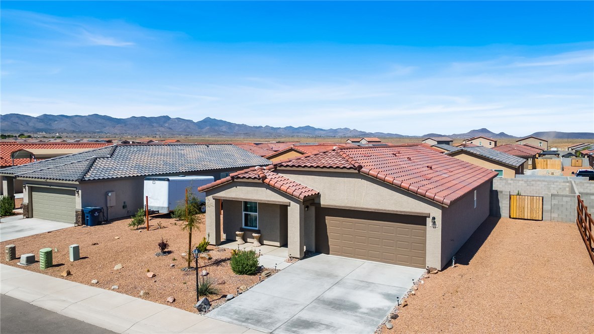 3623 East Andrea Drive Kingman, AZ 86409 - Photo 28 of 40 This property features a single-story home with a two-car garage and a concrete driveway