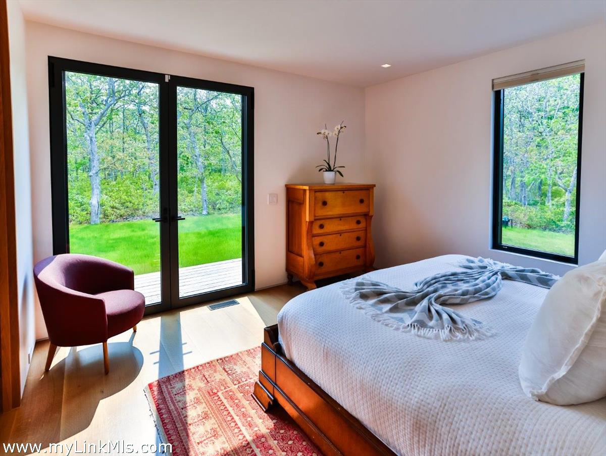 4 Jacob's Neck Road Edgartown, MA 02539 - Photo 6 of 20 a bedroom with a bed and a large window