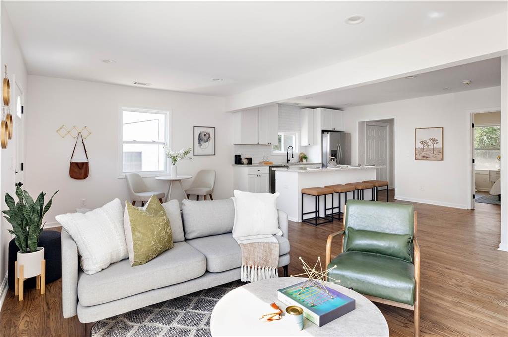 a living room with furniture and a wooden floor