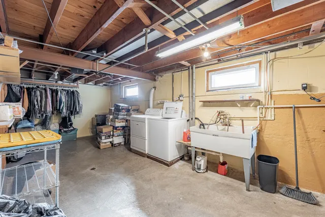 a view of a backyard with table and chairs plants and wooden fence