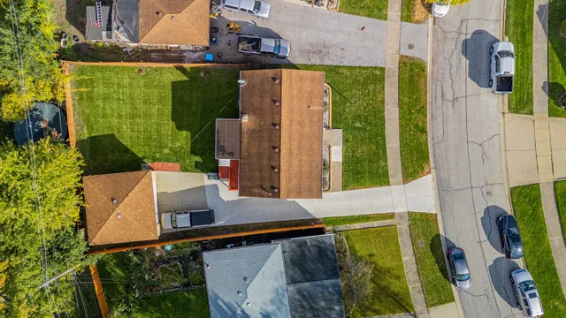 an aerial view of a house with a yard