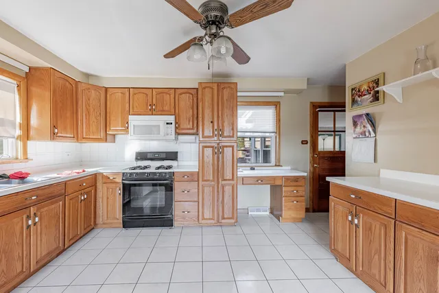 a kitchen with stainless steel appliances granite countertop a stove sink and cabinets