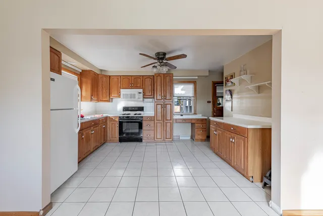 a kitchen with stainless steel appliances a sink and a refrigerator