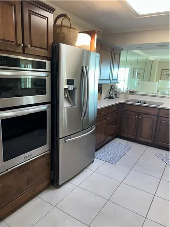 a kitchen with stainless steel appliances granite countertop a refrigerator and a stove top oven