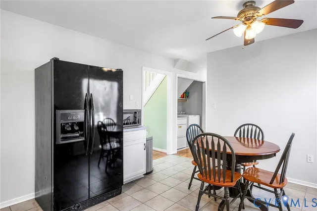 a kitchen with stainless steel appliances kitchen island a dining table and chairs