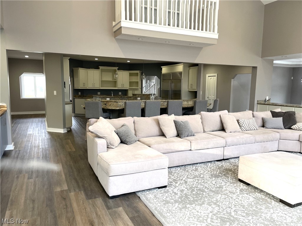 9427 Hubbard Valley Road Seville, OH 44273 - Photo 12 of 34 Living room featuring dark wood-type flooring and a towering ceiling
