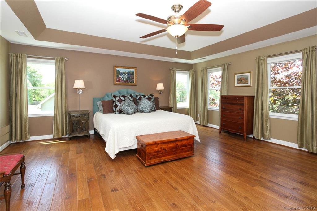 3375 Blue Jay Pass, Unit 10 Fort Mill, SC 29708 - Photo 14 of 30 a spacious bedroom with a bed and wooden floor