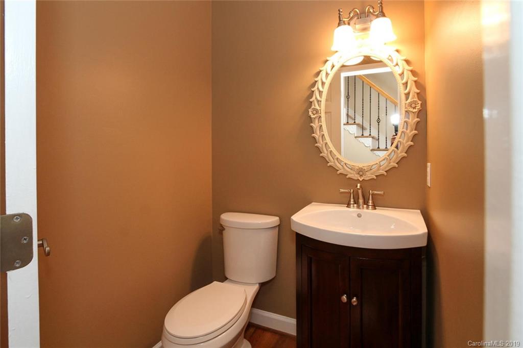 3375 Blue Jay Pass, Unit 10 Fort Mill, SC 29708 - Photo 10 of 30 a bathroom with a toilet a sink and mirror