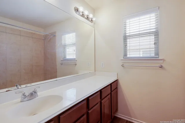 a bathroom with a sink and a window