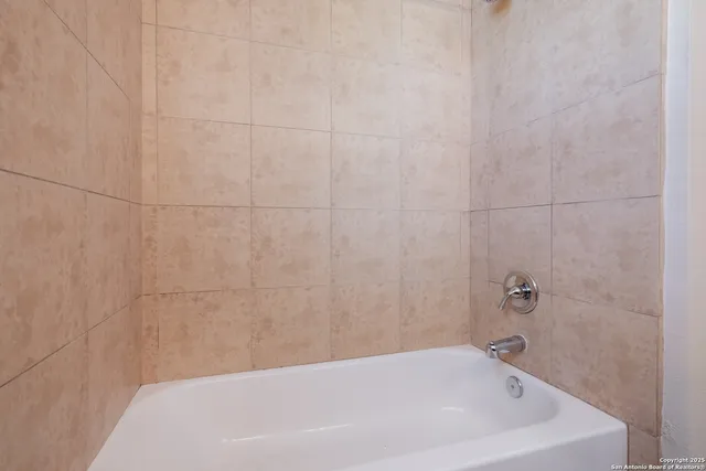 a bathroom with a white bath tub