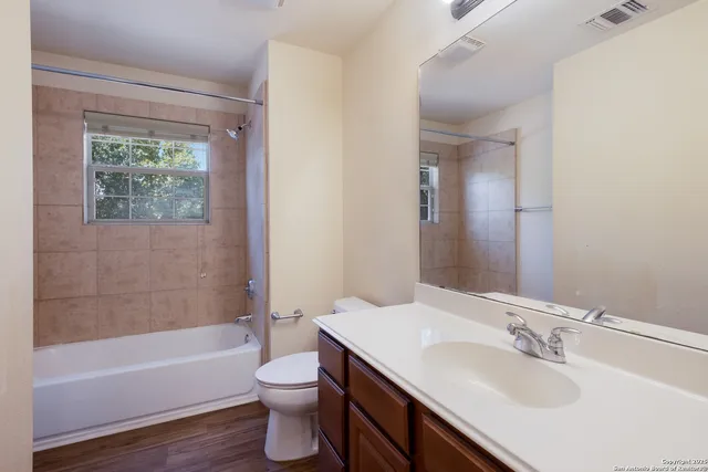 a bathroom with a sink toilet tub and shower