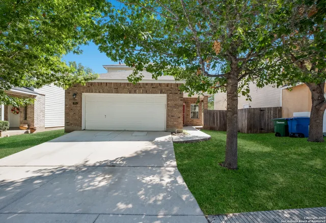 a front view of house with a garden