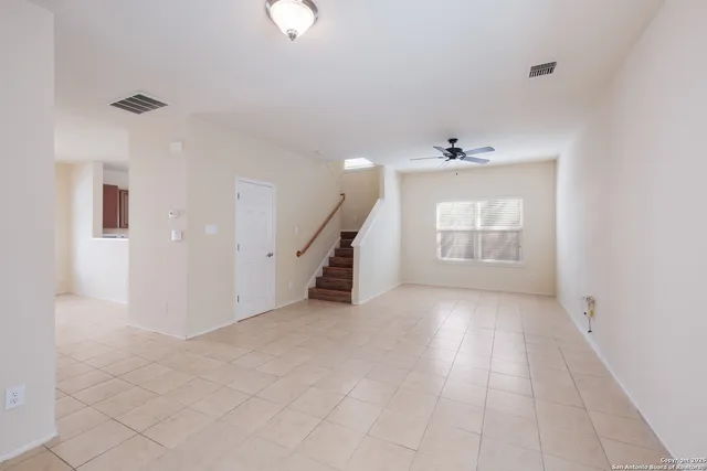 an empty room with windows and pillars in it