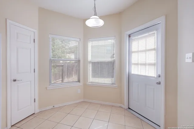 a view of an empty room with windows