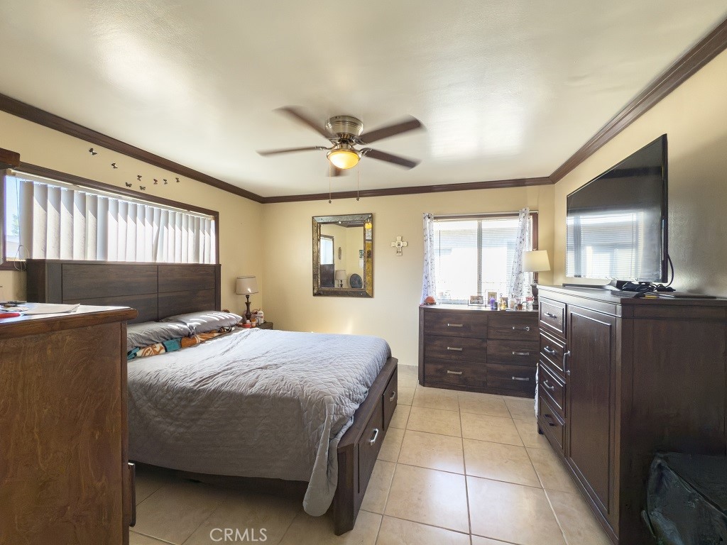 7850 Birchcrest Road Downey, CA 90240 - Photo 11 of 18 a bedroom with a bed and wooden floor
