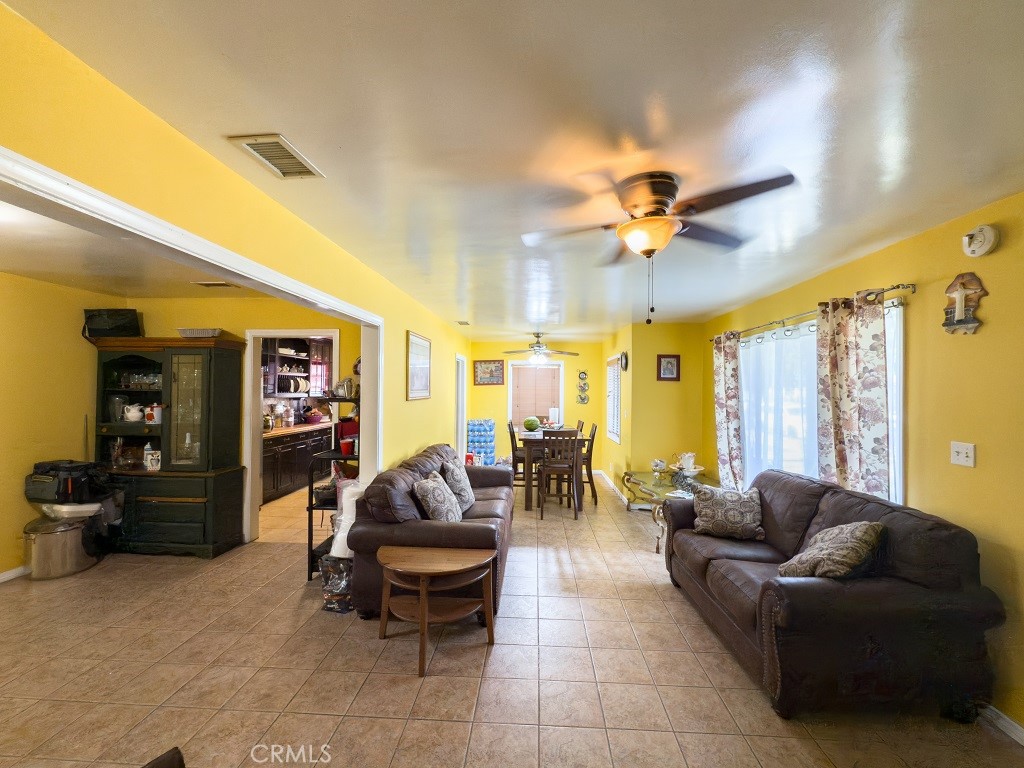 7850 Birchcrest Road Downey, CA 90240 - Photo 8 of 18 a living room with furniture and a ceiling fan