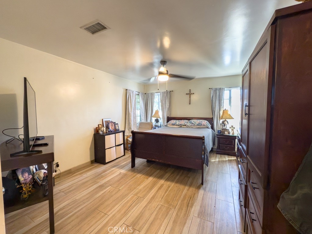 7850 Birchcrest Road Downey, CA 90240 - Photo 10 of 18 a large room with wooden floor and furniture