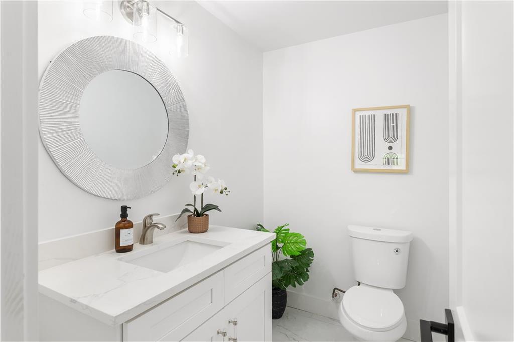 399 Old Canton Road Marietta, GA 30068 - Photo 20 of 26 a bathroom with a toilet sink and mirror