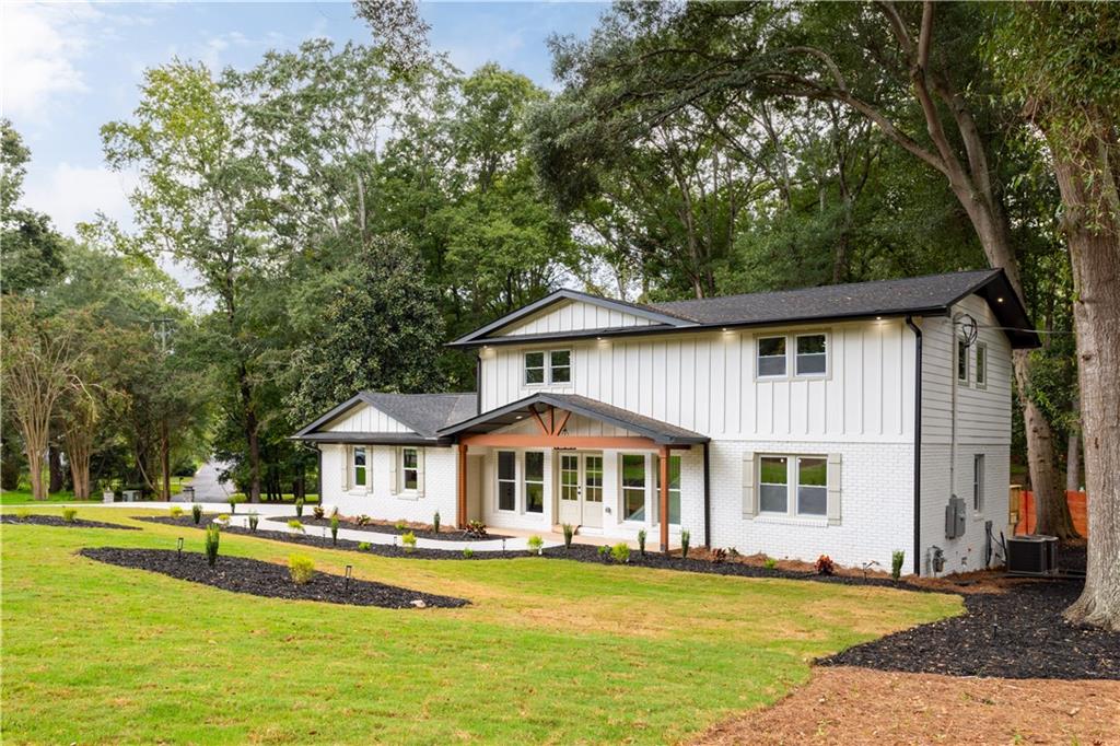 399 Old Canton Road Marietta, GA 30068 - Photo 2 of 26 a front view of a house with swimming pool