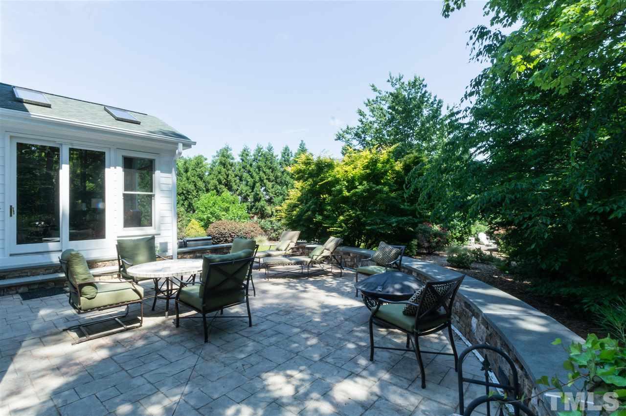 301 Pond Bluff Way Cary, NC 27513 - Photo 22 of 25 a view of a patio with table and chairs and potted plants