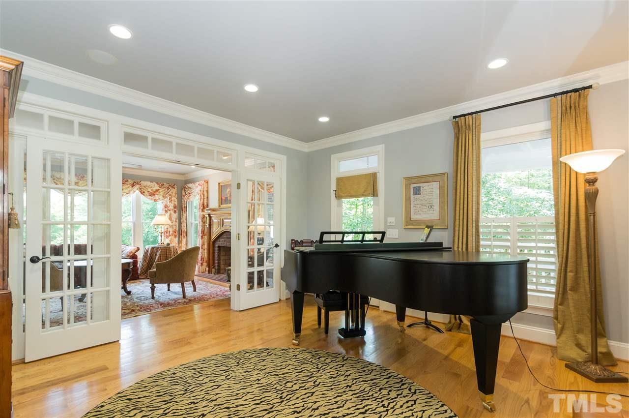 301 Pond Bluff Way Cary, NC 27513 - Photo 4 of 25 a living room with furniture a large window and dining table