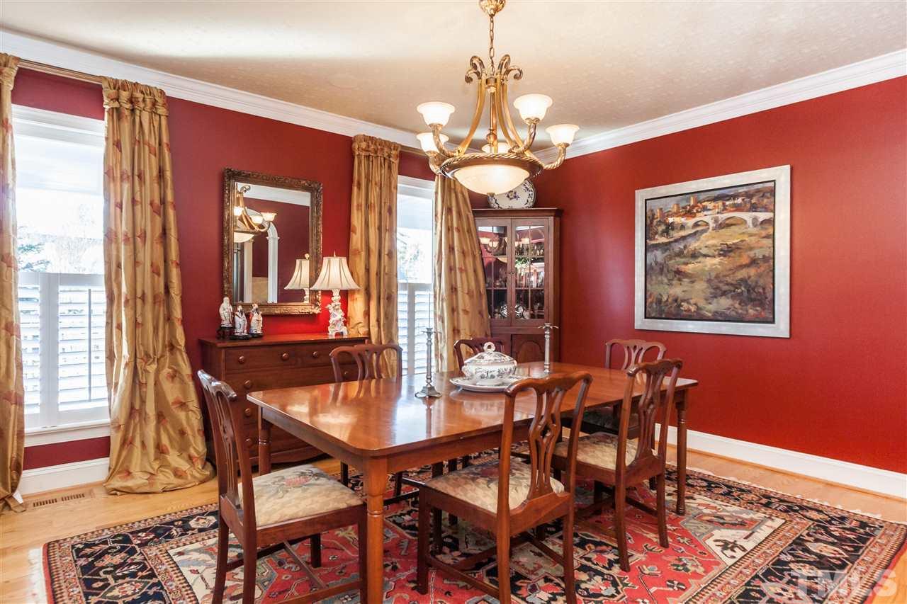 301 Pond Bluff Way Cary, NC 27513 - Photo 5 of 25 a dining room with furniture a chandelier and wooden floor