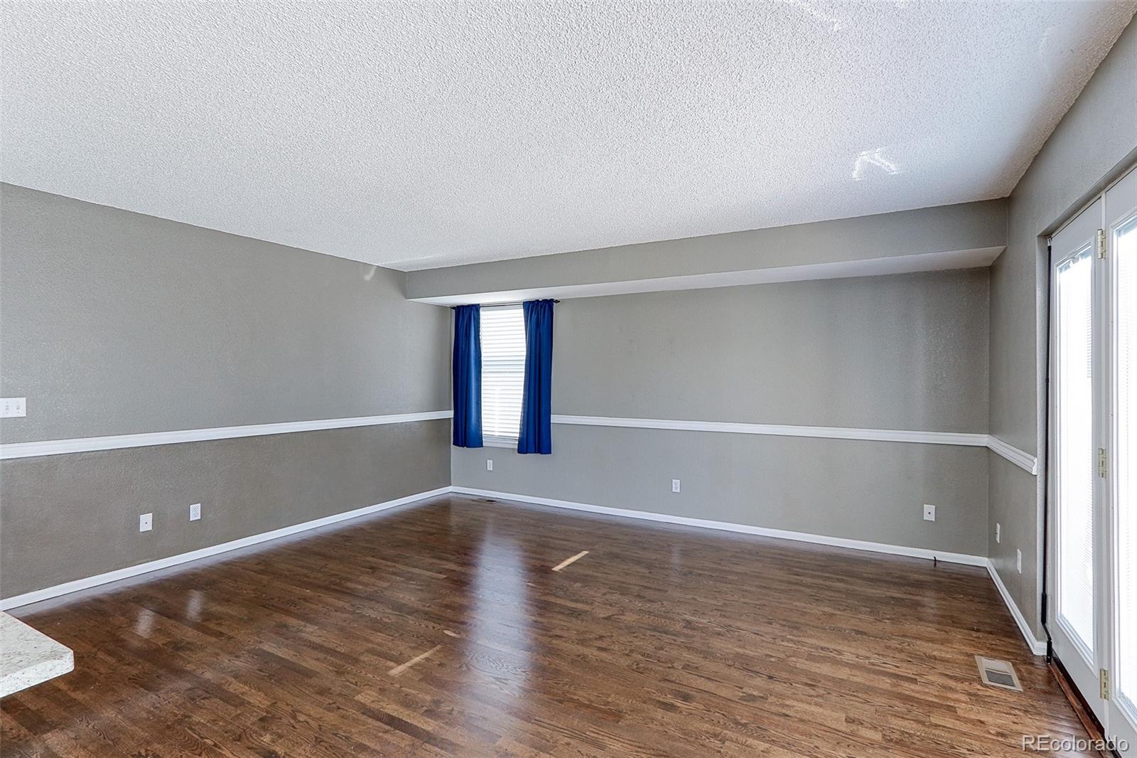 9068 West 101st Avenue Broomfield, CO 80021 - Photo 11 of 34 wooden floor in an empty room with a window