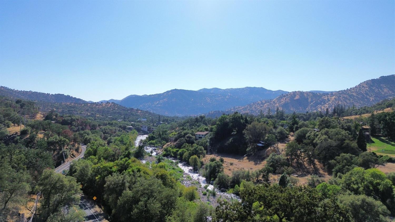 369 August Drive Three Rivers, CA 93271 - Photo 1 of 12 a view of a lush green field with mountains in the background