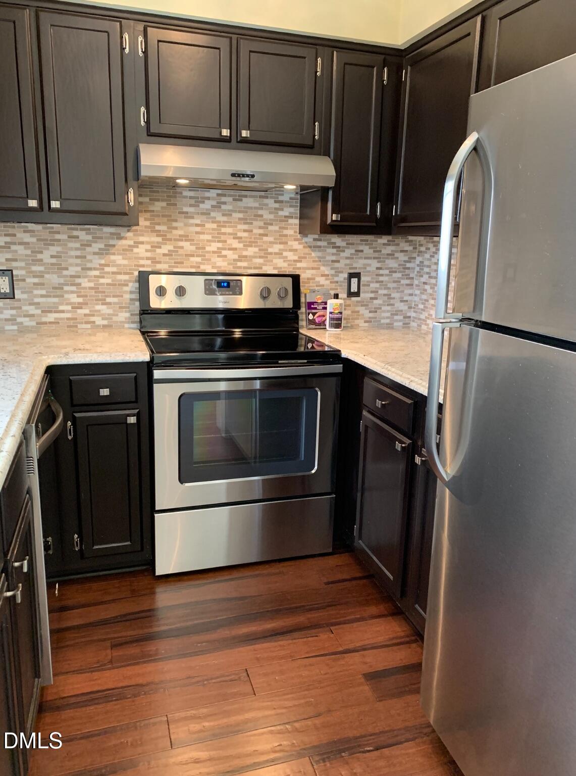 710 Powell Drive, Unit C Raleigh, NC 27606 - Photo 12 of 24 a kitchen with granite countertop a refrigerator stove and sink