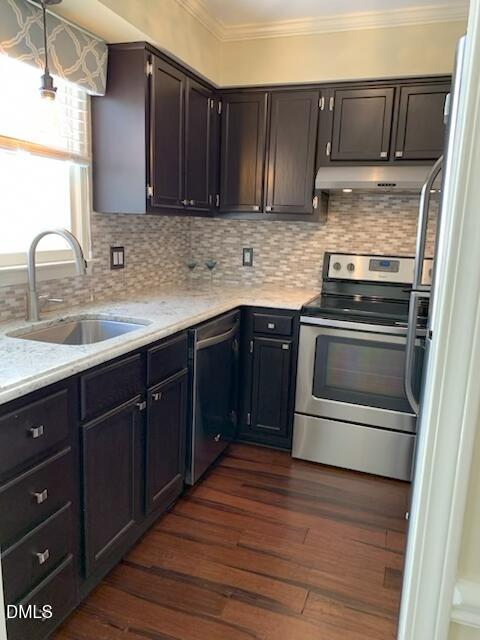 710 Powell Drive, Unit C Raleigh, NC 27606 - Photo 13 of 24 a kitchen with stainless steel appliances granite countertop a sink stove and cabinets
