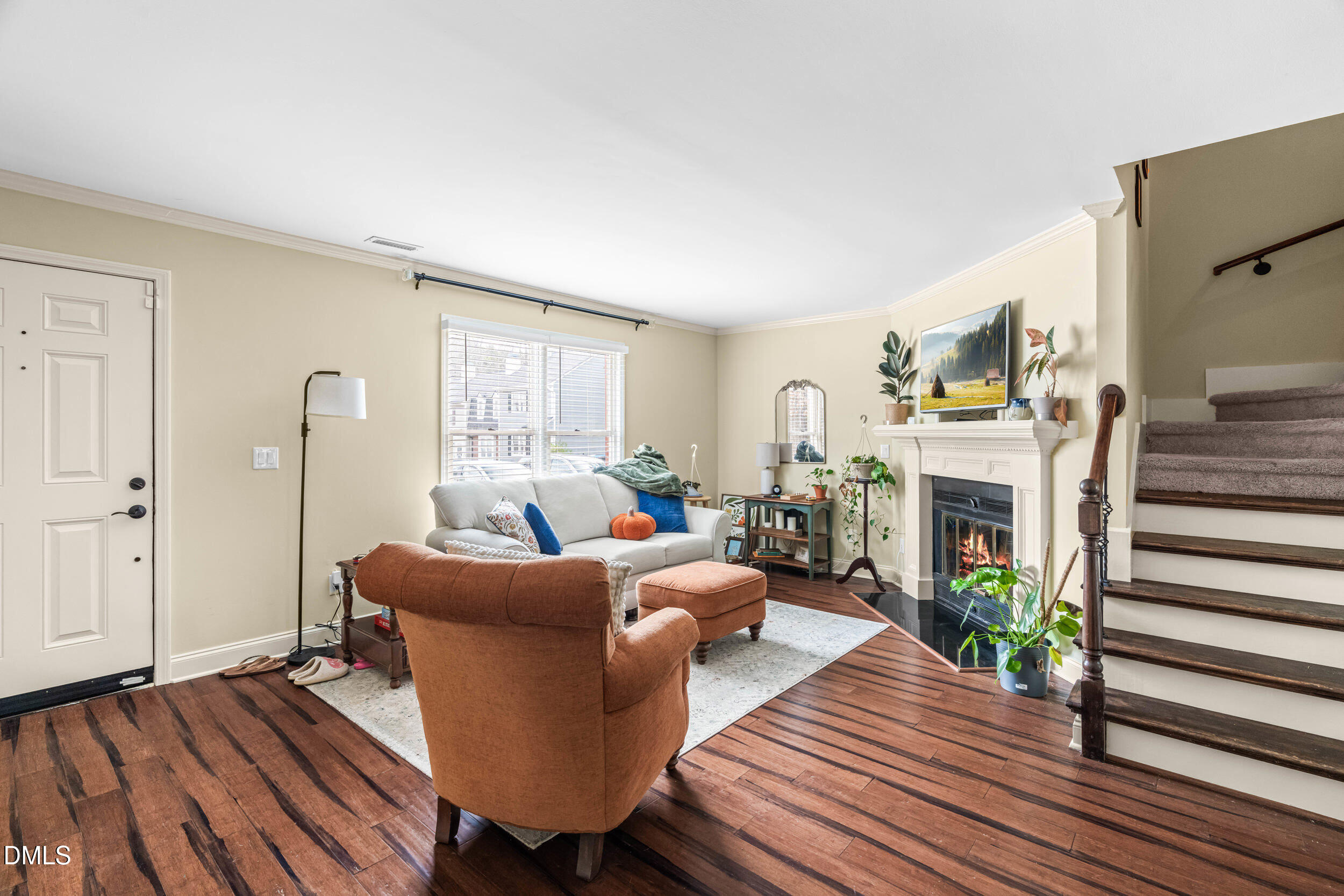 710 Powell Drive, Unit C Raleigh, NC 27606 - Photo 6 of 24 a living room with furniture a fireplace and wooden floor