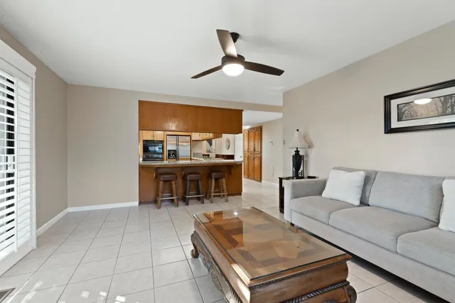 a living room with furniture and kitchen view