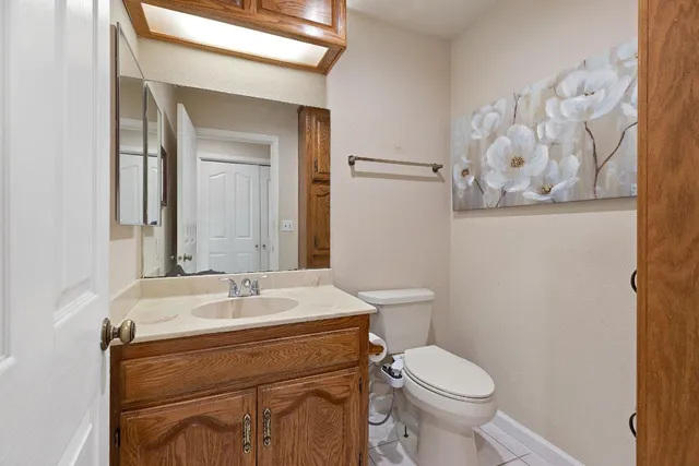 a bathroom with a sink mirror vanity and toilet