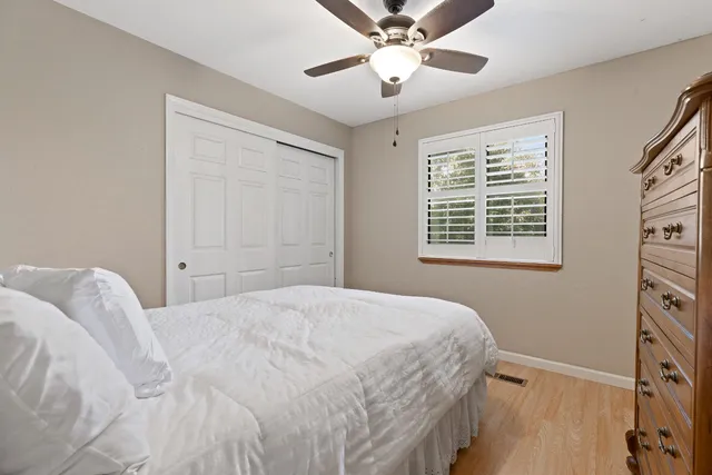 a bedroom with a large bed and a window
