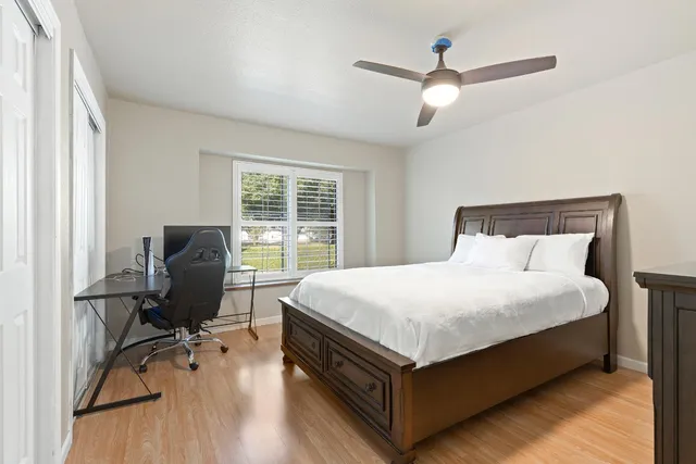 a bed sitting in a bedroom next to a window
