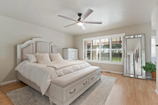 a bed room with a bed and a large window