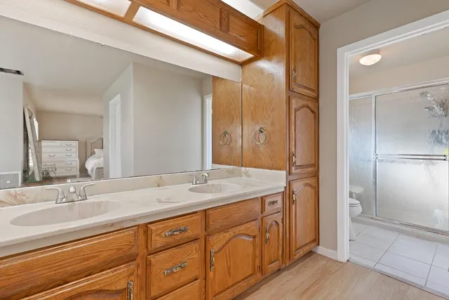 a bathroom with a sink double vanity and a mirror