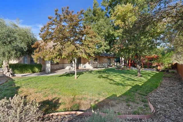 a backyard of a house with table and chairs