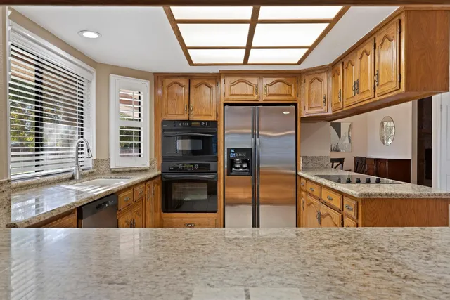 a kitchen with stainless steel appliances granite countertop a stove and a sink