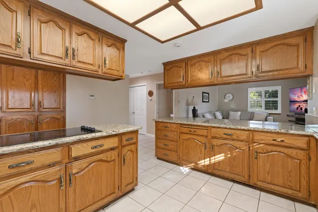 a kitchen with cabinets stainless steel appliances and a counter top space