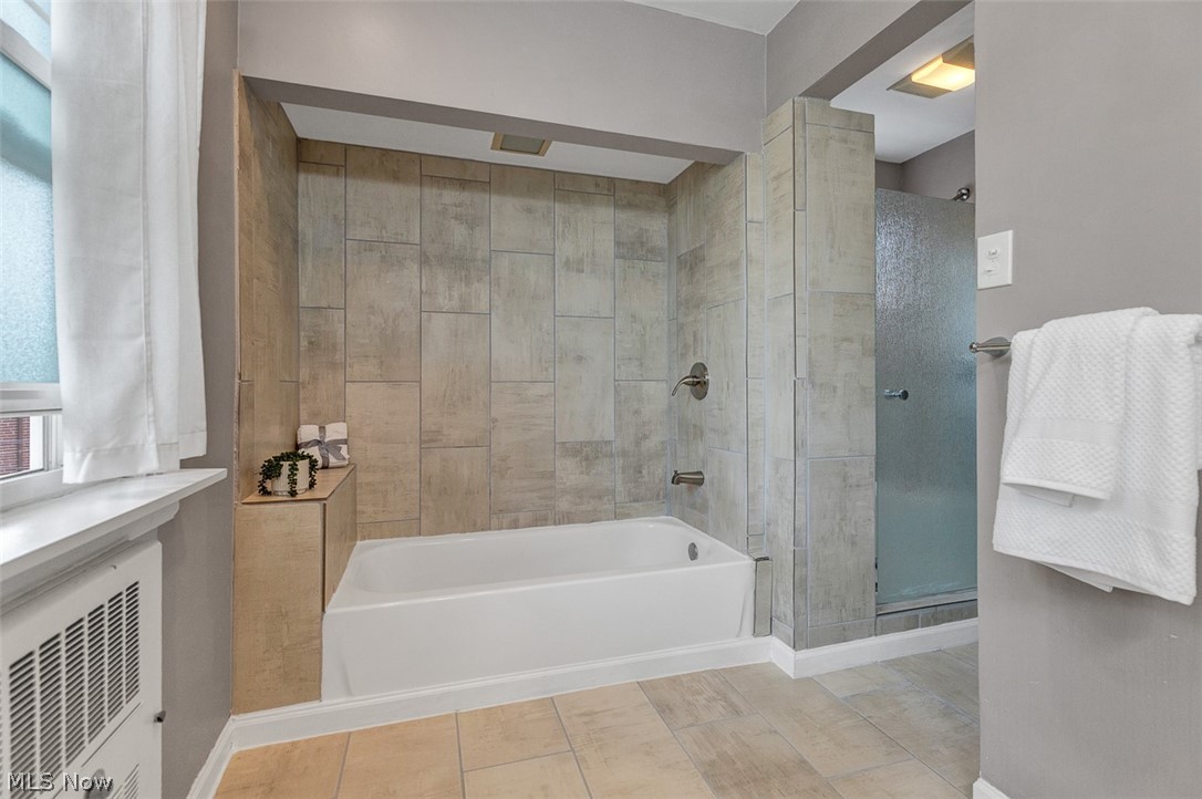 2972 Yorkshire Road Cleveland Heights, OH 44118 - Photo 33 of 44 Bathroom featuring a tub/shower combination with tile surround and brushed nickel fixtures