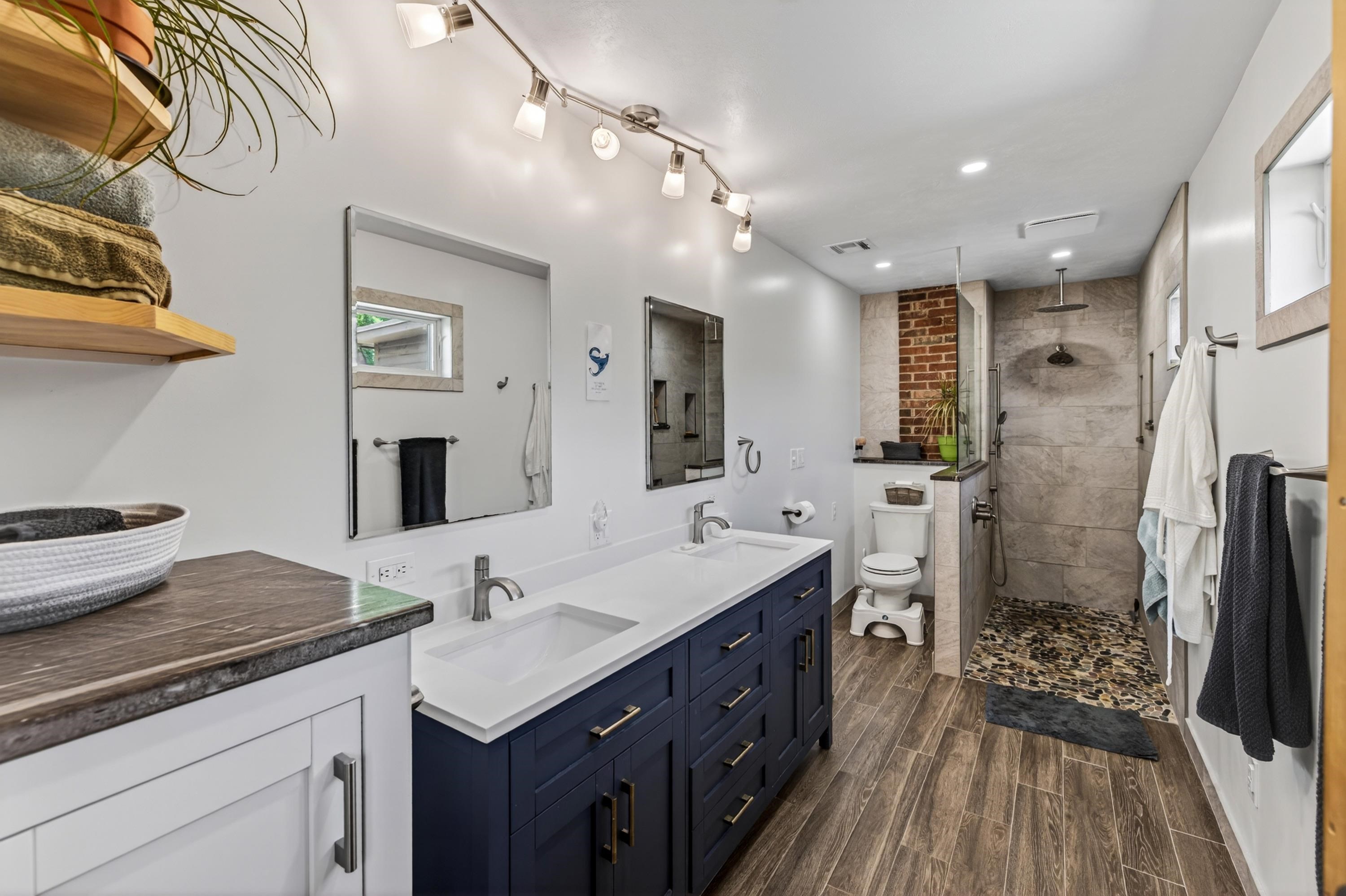 3980 Greenmount Road Harrisonburg, VA 22802 - Photo 33 of 75 The primary bathroom offers dual vanities, tile shower, and large cabinetry with storage. This space offers updated lighting fixtures and many updates throughout!