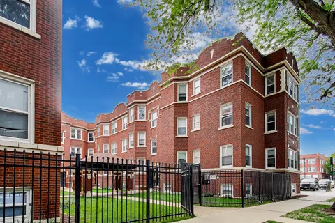 a view of a brick building next to a yard