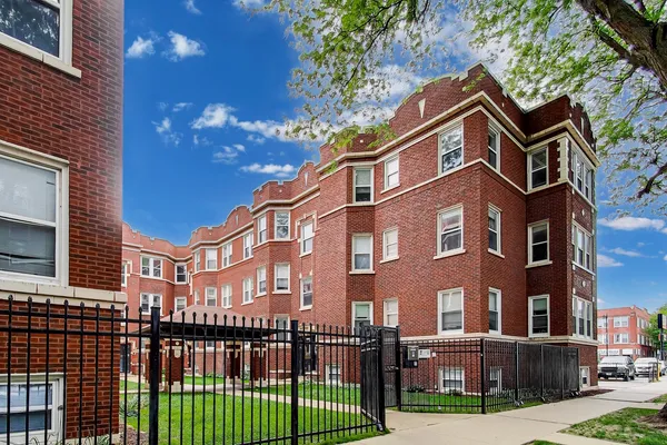 a view of a brick building next to a yard