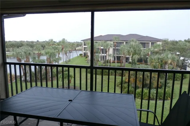 a view of a balcony with wooden floor and fence