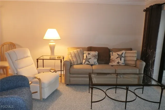 a living room with furniture and a lamp