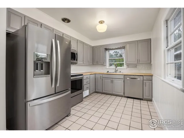 a kitchen with stainless steel appliances a refrigerator sink and cabinets