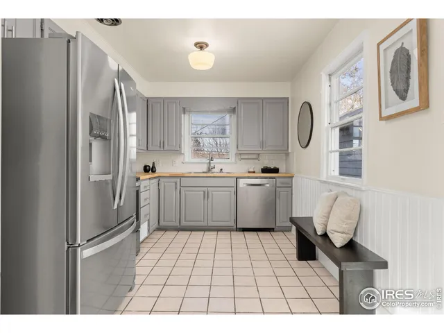a kitchen with stainless steel appliances a refrigerator sink and cabinets