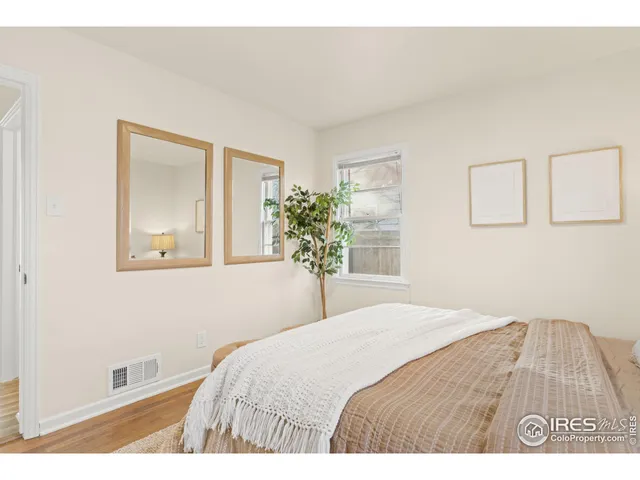 a bedroom with a bed and a potted plant
